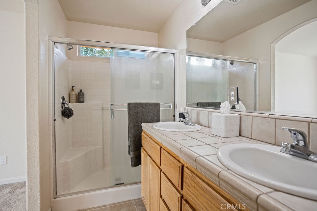2344 Siena Court Merced, CA 95341 - Photo 13 of 19 a bathroom with a sink and a mirror