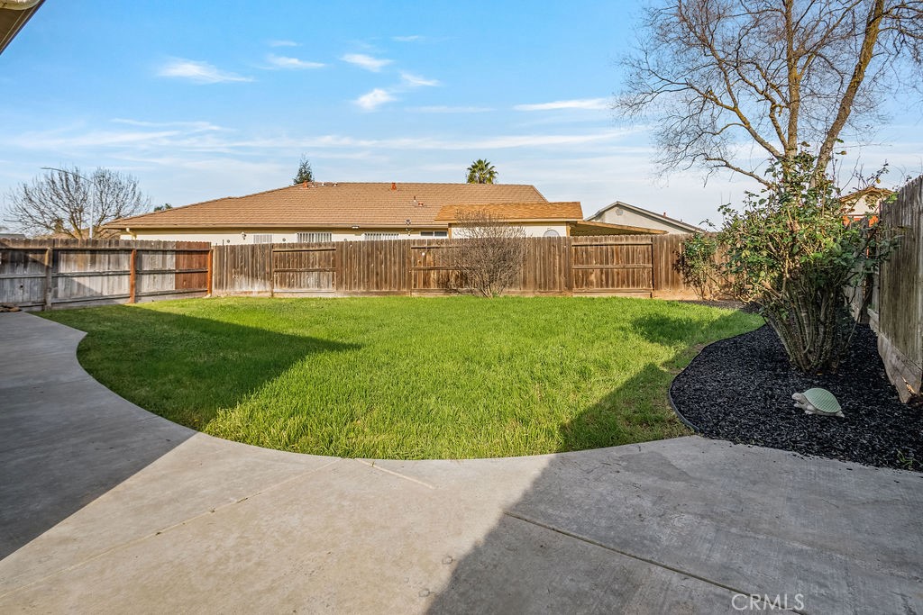 2344 Siena Court Merced, CA 95341 - Photo 16 of 19 a view of a big house with a yard and plants