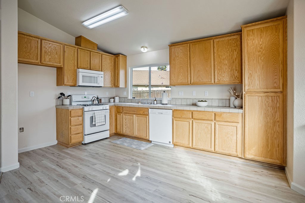 2344 Siena Court Merced, CA 95341 - Photo 4 of 19 a kitchen with stainless steel appliances granite countertop a stove a sink dishwasher and a refrigerator