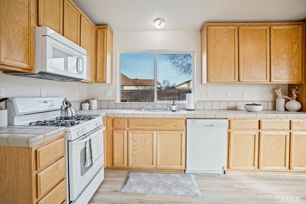 2344 Siena Court Merced, CA 95341 - Photo 5 of 19 a kitchen with stainless steel appliances granite countertop a stove sink and cabinets