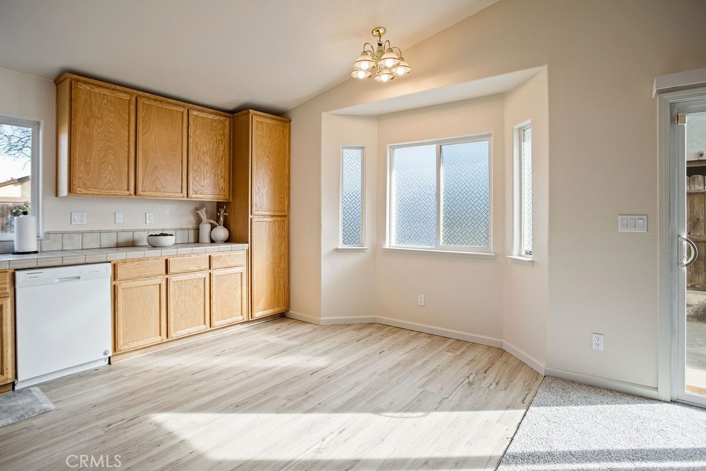 2344 Siena Court Merced, CA 95341 - Photo 6 of 19 a view of a kitchen with wooden floor and electronic appliances