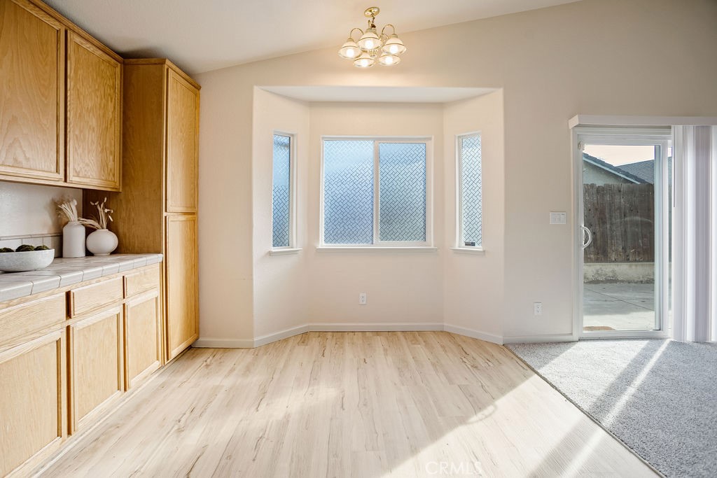 2344 Siena Court Merced, CA 95341 - Photo 7 of 19 a view of a kitchen with wooden floor and a window