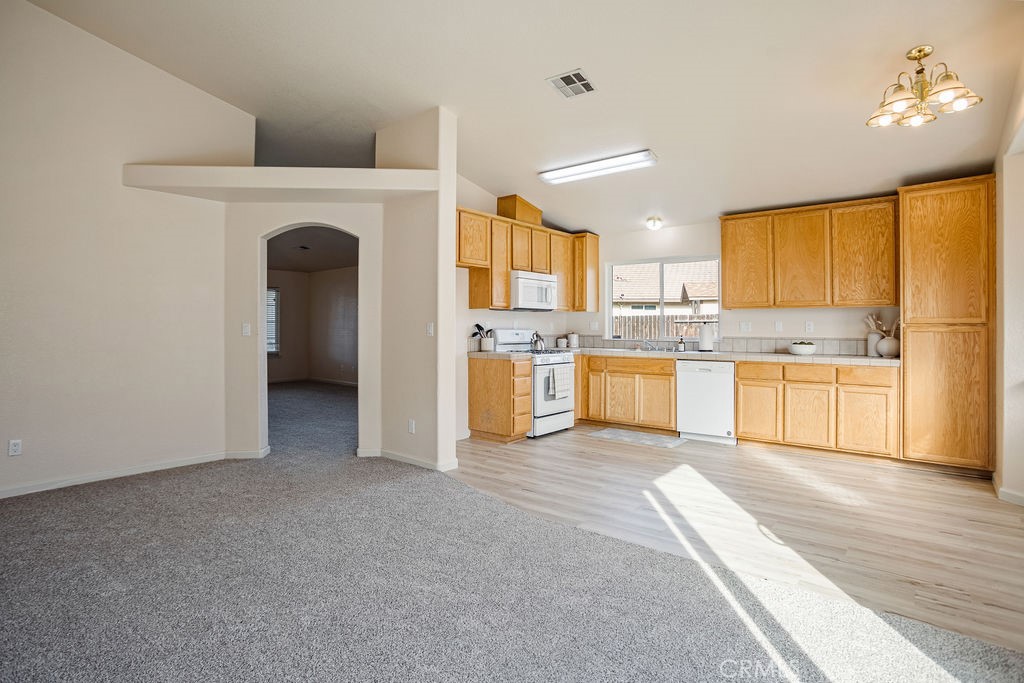 2344 Siena Court Merced, CA 95341 - Photo 8 of 19 a kitchen with stainless steel appliances granite countertop a stove oven and a refrigerator