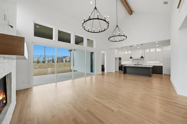 a view of a room with wooden floor and ceiling fan