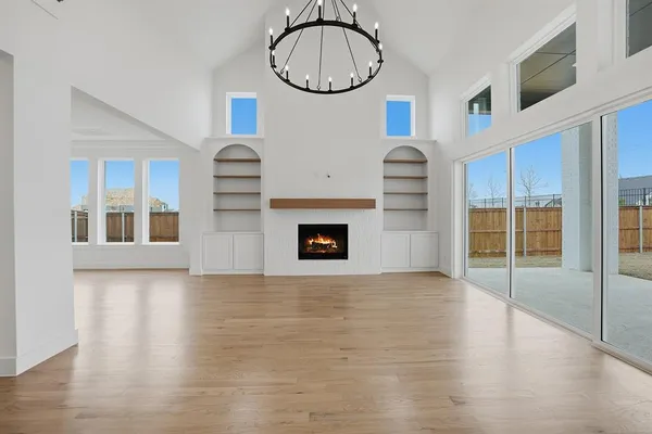 a large room with a large window and wooden floor