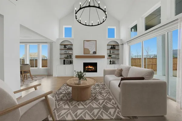 a kitchen with stainless steel appliances granite countertop a sink a stove a refrigerator and island with wooden floor