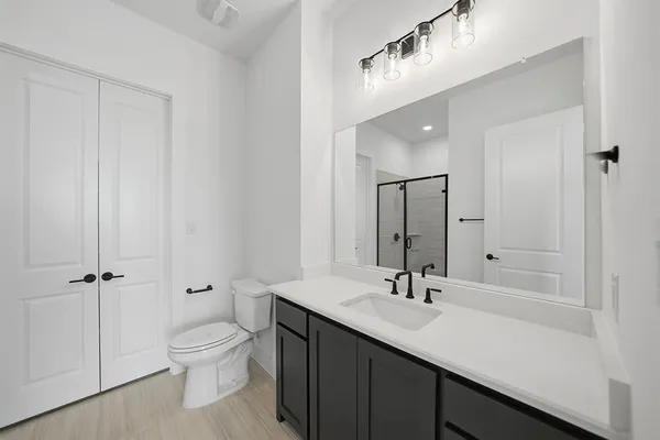 a view of a hallway with wooden floor and entryway