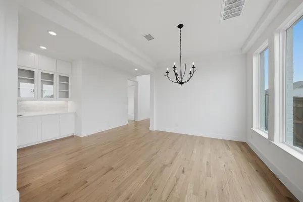 a view of open kitchen with granite countertop a stove and a wooden floor