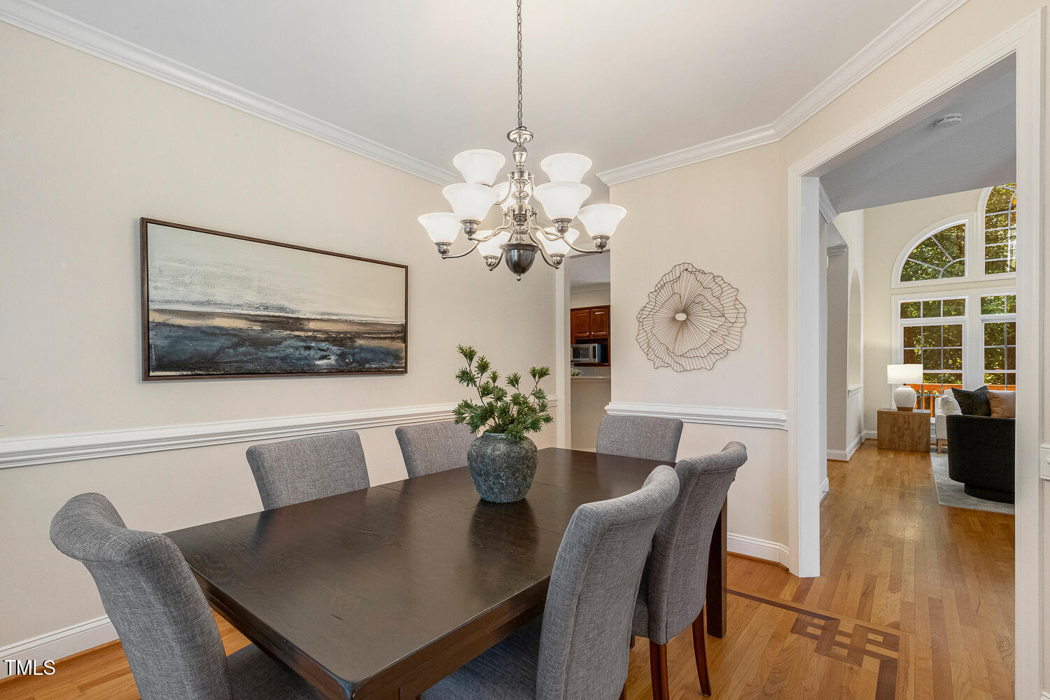2628 Hunters Meadow Lane Raleigh, NC 27606 - Photo 12 of 76 a dining room with wooden floor a chandelier a wooden table and chairs