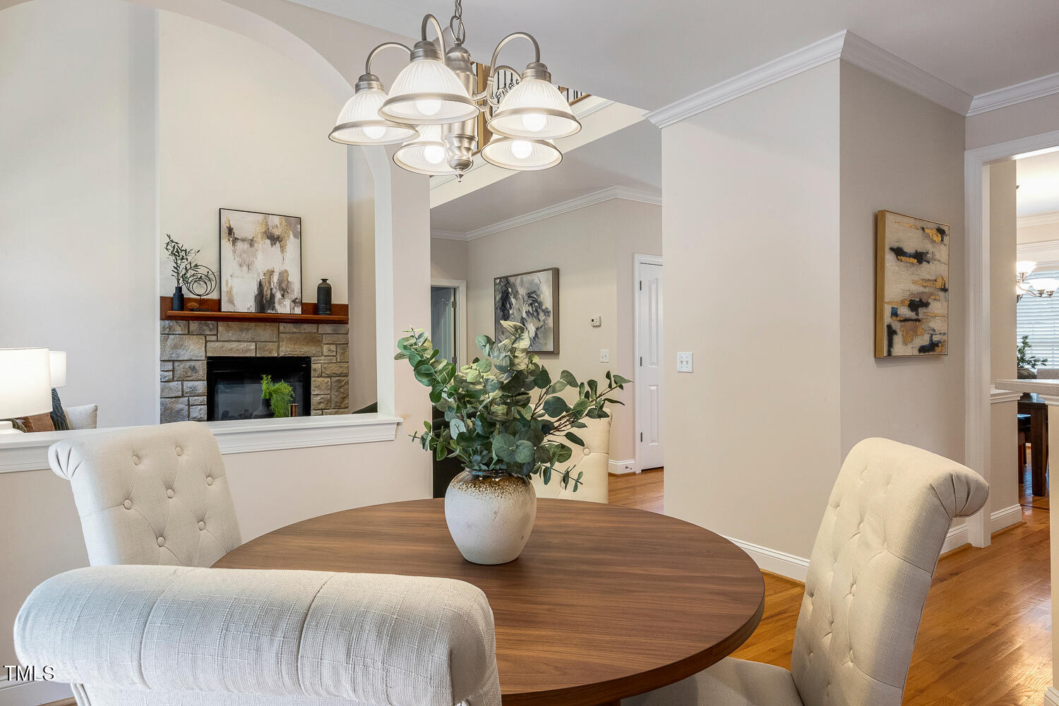 2628 Hunters Meadow Lane Raleigh, NC 27606 - Photo 21 of 76 a living room with furniture a chandelier and a fireplace