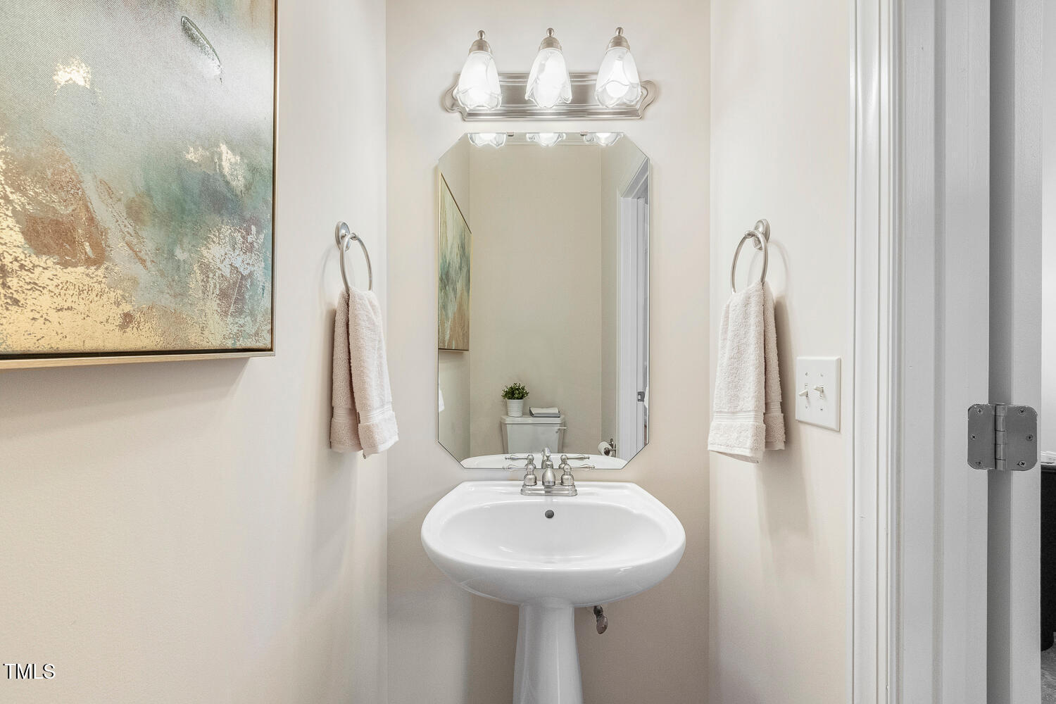 2628 Hunters Meadow Lane Raleigh, NC 27606 - Photo 28 of 76 a bathroom with a sink and a mirror