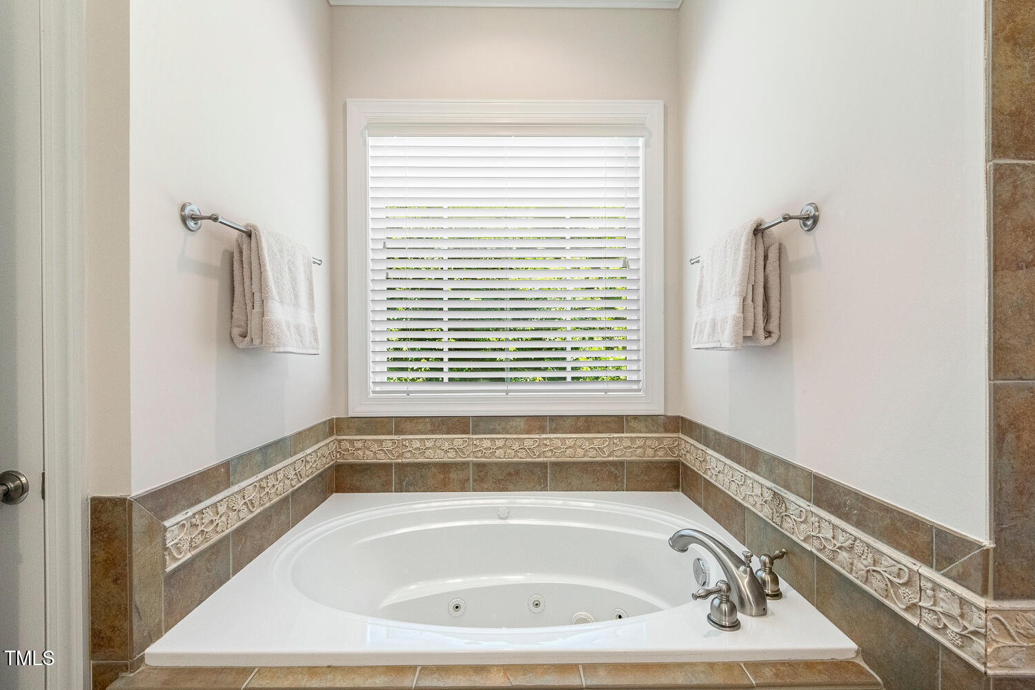 2628 Hunters Meadow Lane Raleigh, NC 27606 - Photo 40 of 76 a bathroom with a bath tub and a window