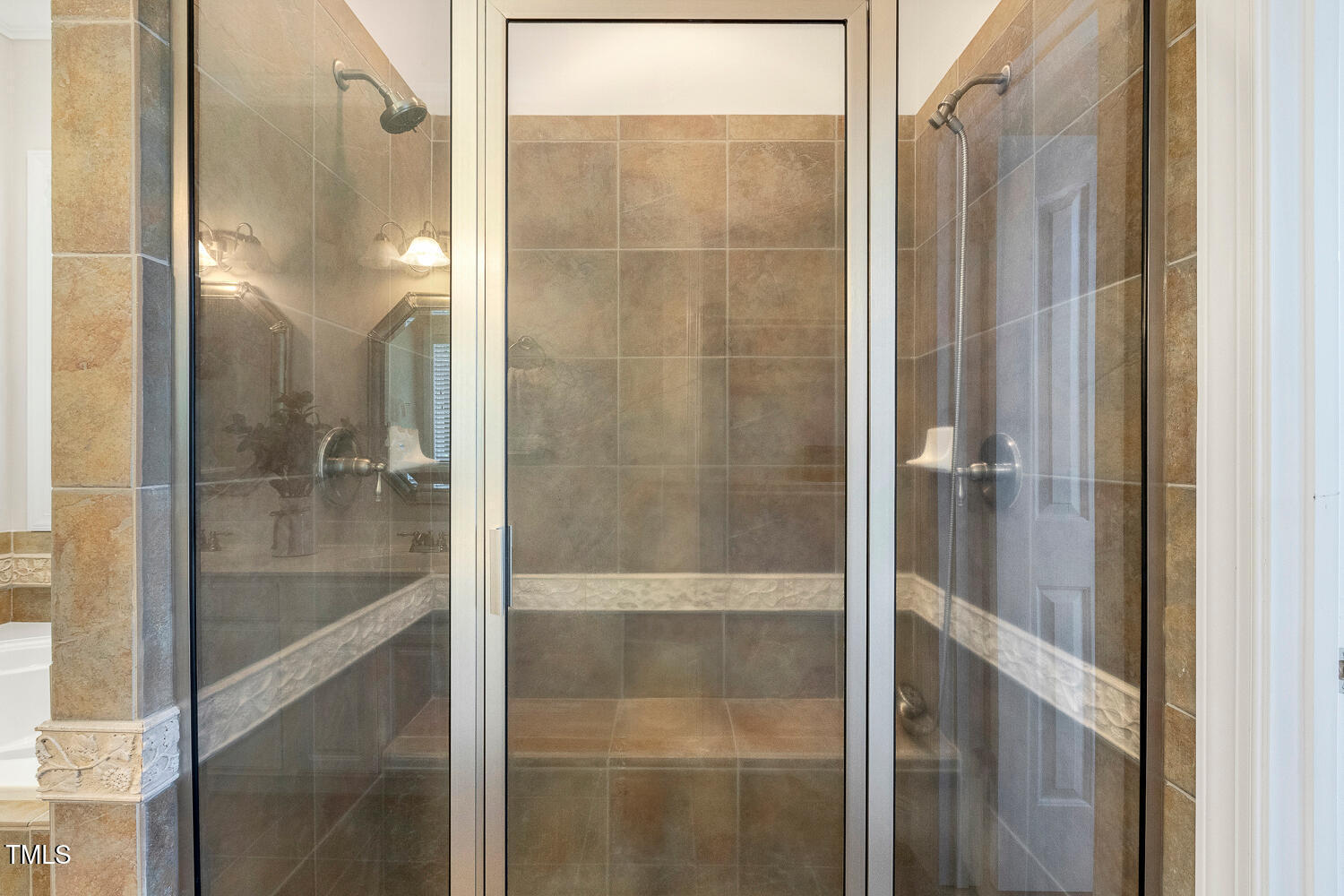 2628 Hunters Meadow Lane Raleigh, NC 27606 - Photo 41 of 76 a bathroom with a glass shower door