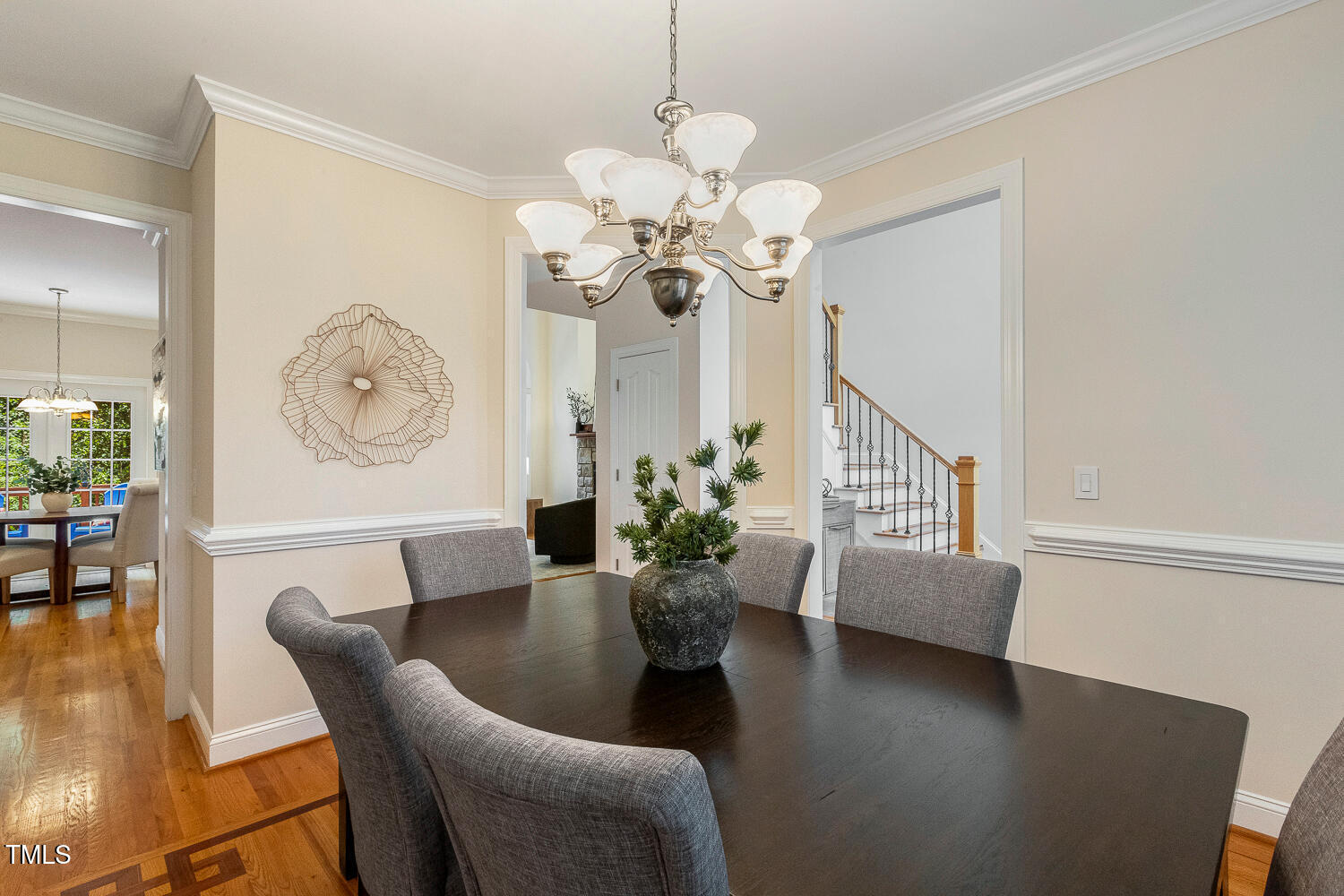 2628 Hunters Meadow Lane Raleigh, NC 27606 - Photo 10 of 76 a view of a dining room with furniture a potted plant and wooden floor