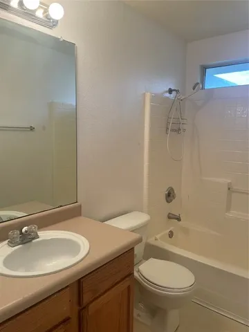 a bathroom with a sink toilet mirror and shower