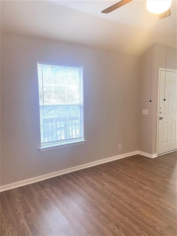 3201 C El Salido Parkway, Unit 221 Cedar Park, TX 78613 - Photo 4 of 18 an empty room with wooden floor and windows