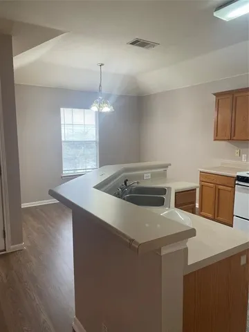 a kitchen that has a sink and a stove in it