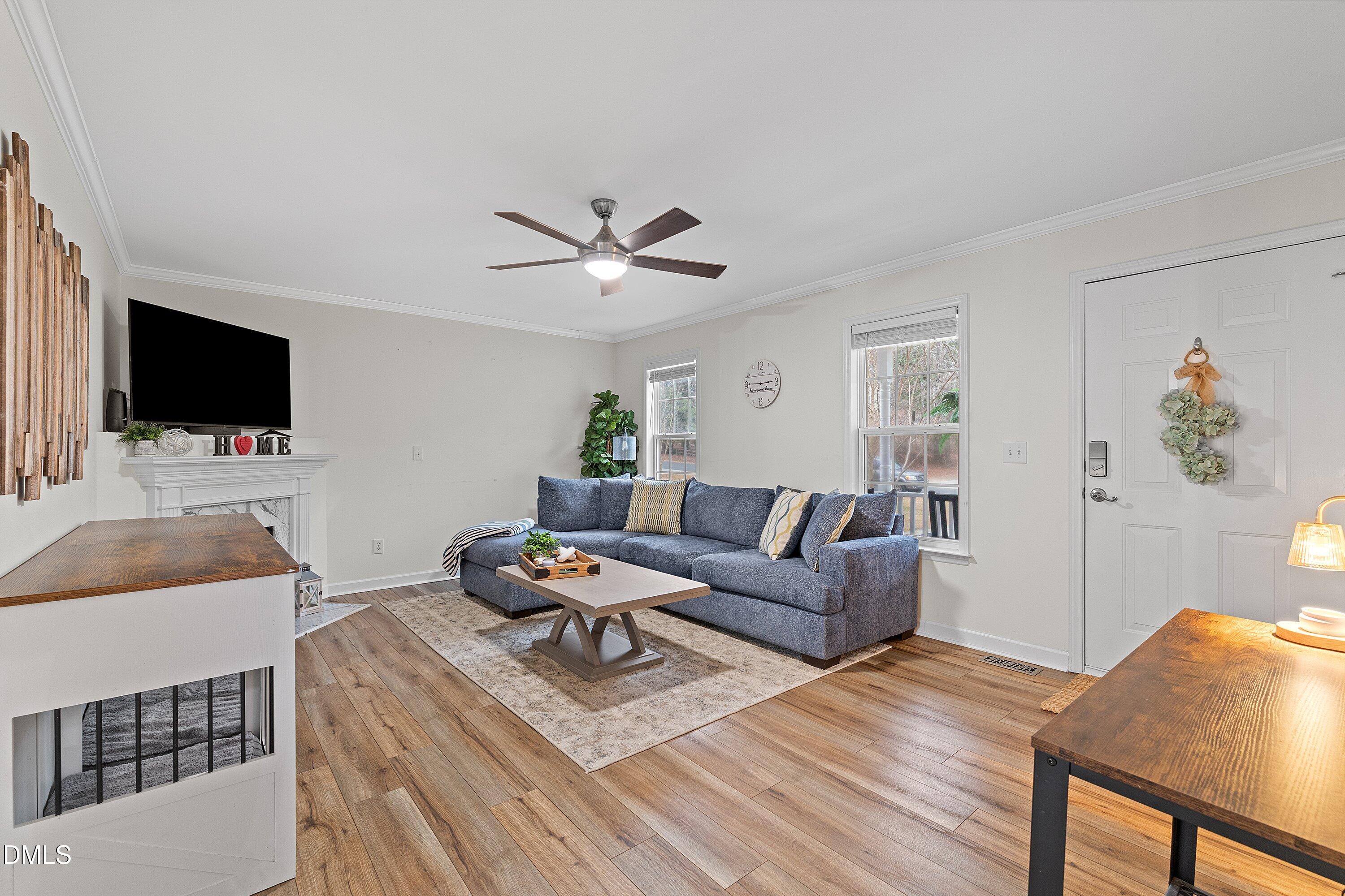 234 Linville Lane Willow Spring, NC 27592 - Photo 10 of 34 a living room with furniture and a flat screen tv