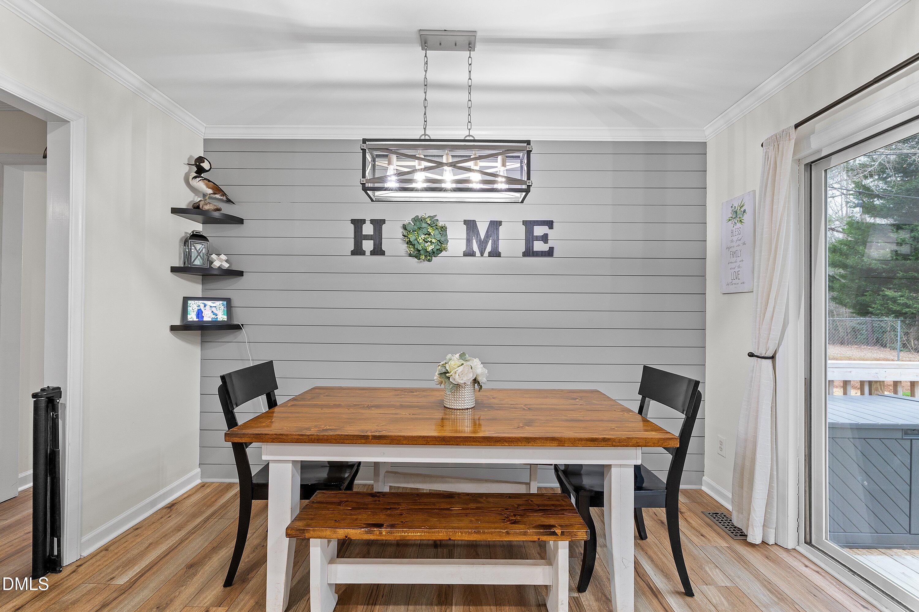 234 Linville Lane Willow Spring, NC 27592 - Photo 11 of 34 a view of a dining room with furniture and wooden floor