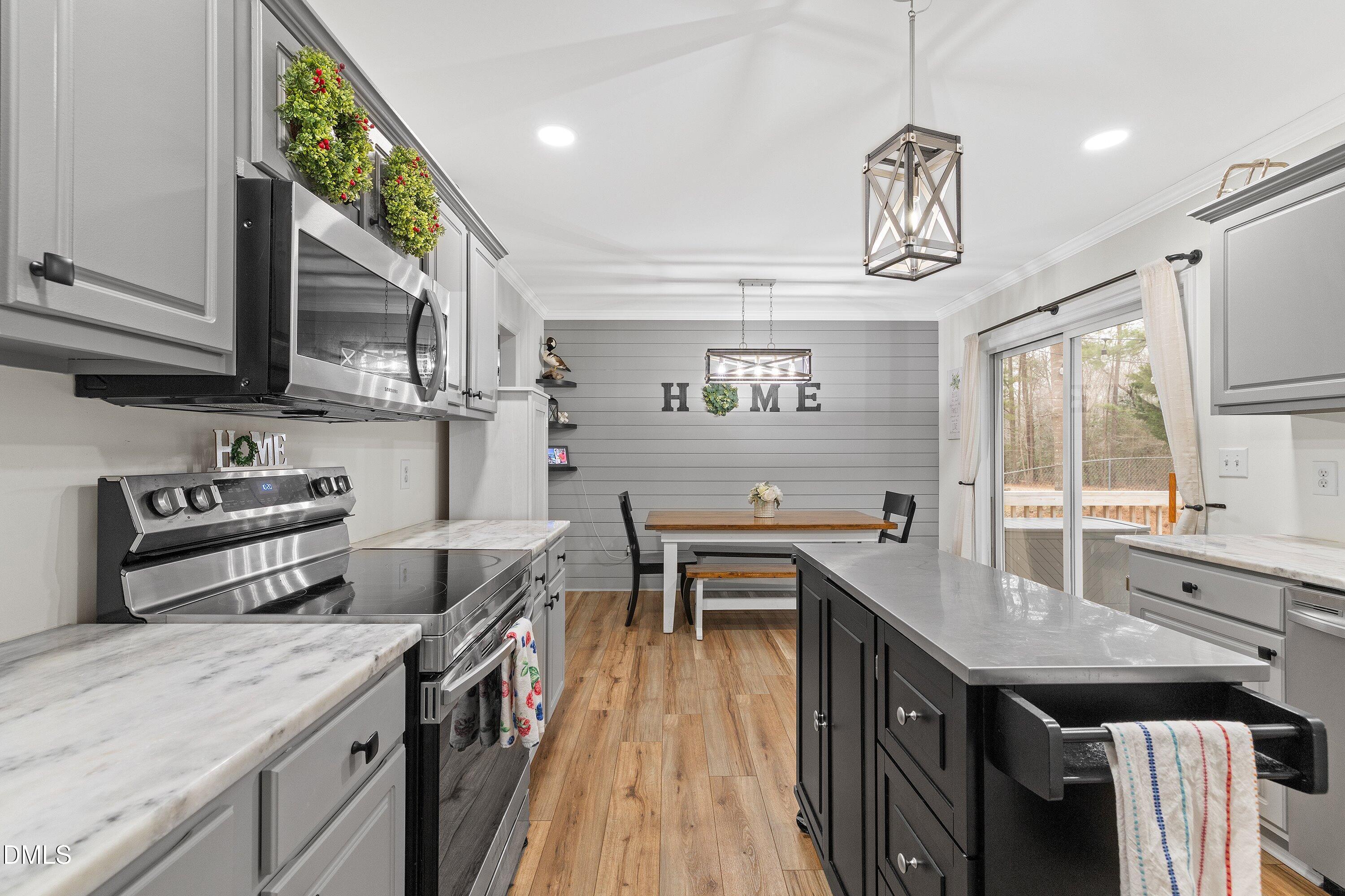 234 Linville Lane Willow Spring, NC 27592 - Photo 12 of 34 a kitchen with a stove a refrigerator and a sink