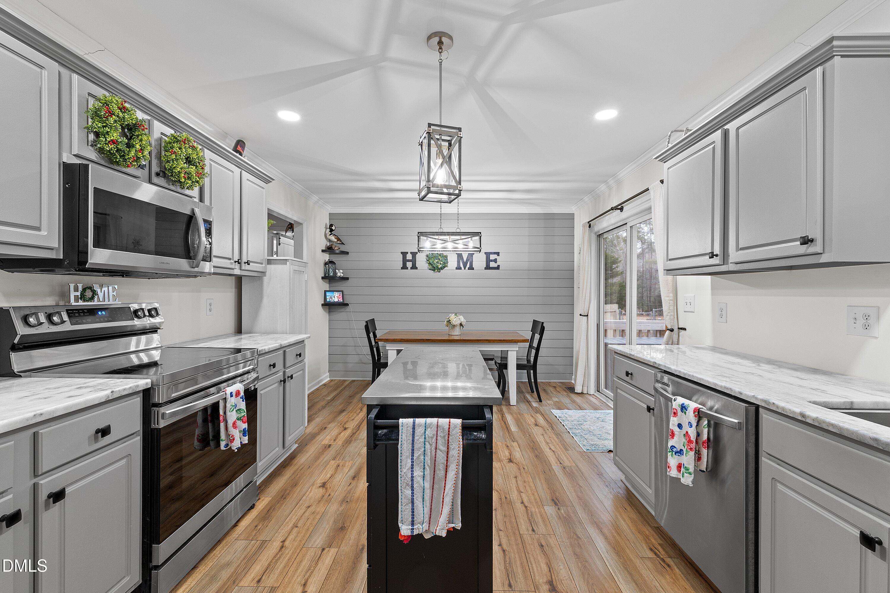 234 Linville Lane Willow Spring, NC 27592 - Photo 13 of 34 a kitchen with stainless steel appliances granite countertop a stove and cabinets
