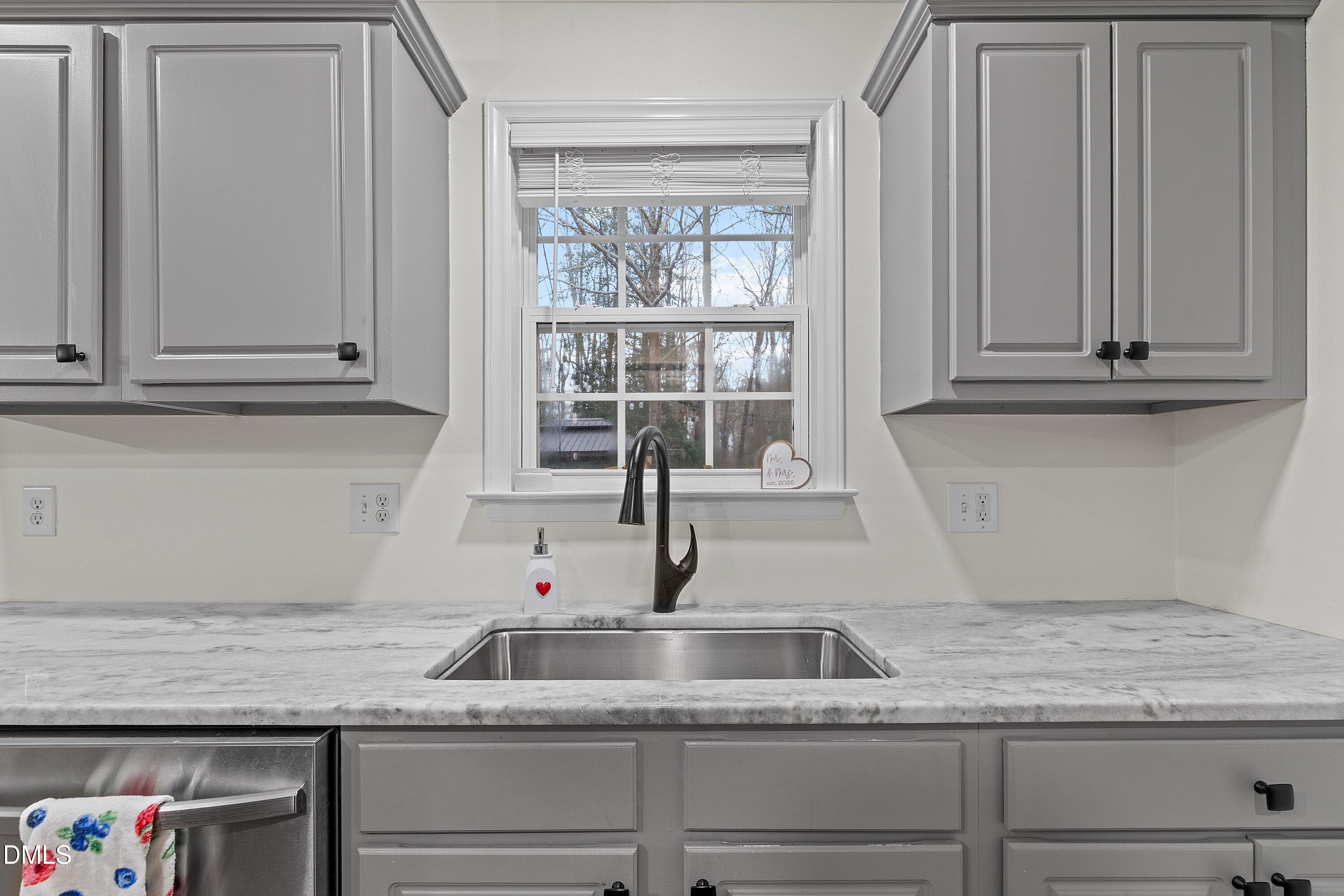 234 Linville Lane Willow Spring, NC 27592 - Photo 14 of 34 a kitchen with granite countertop white cabinets and a sink