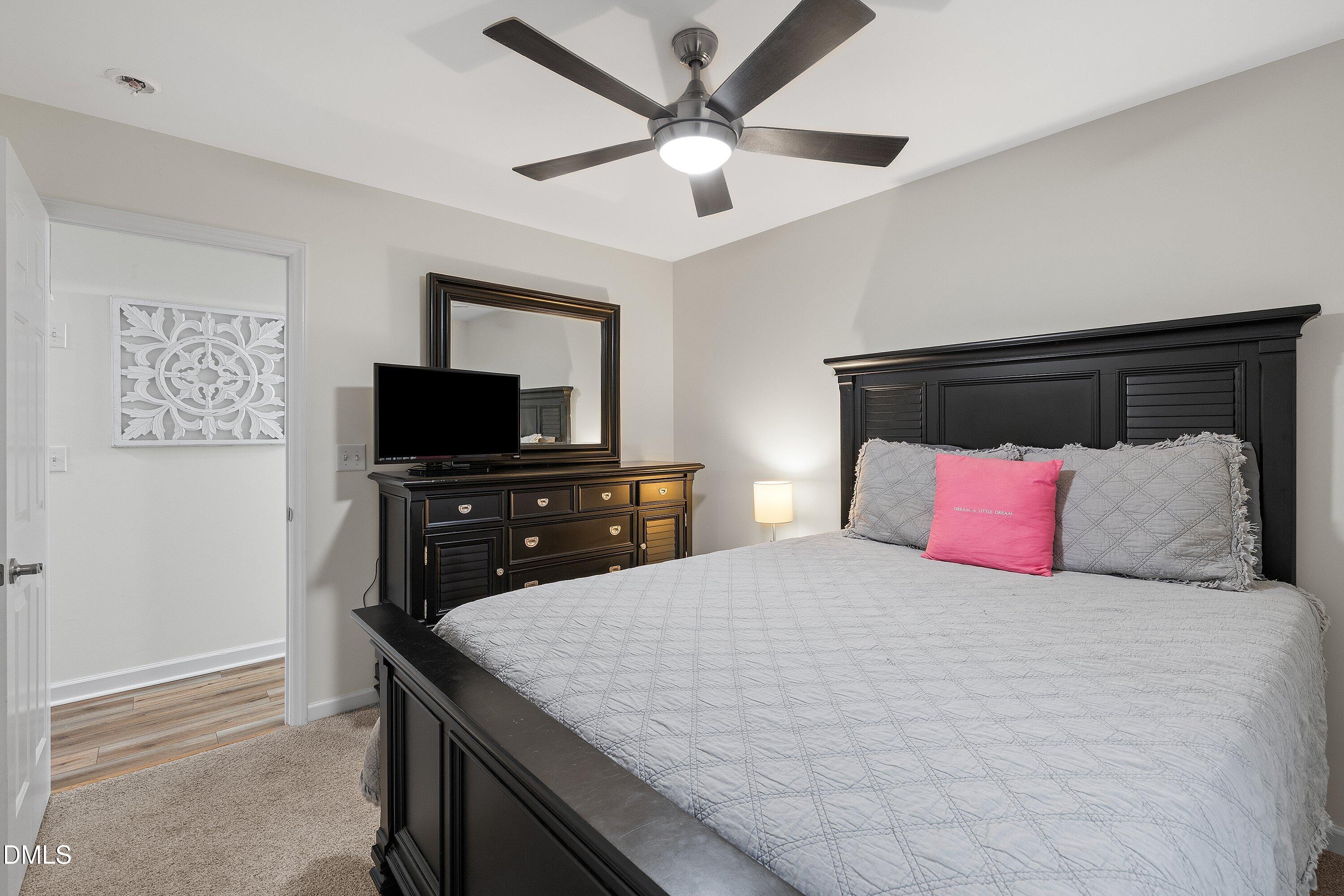234 Linville Lane Willow Spring, NC 27592 - Photo 19 of 34 a bedroom with a bed and a flat screen tv