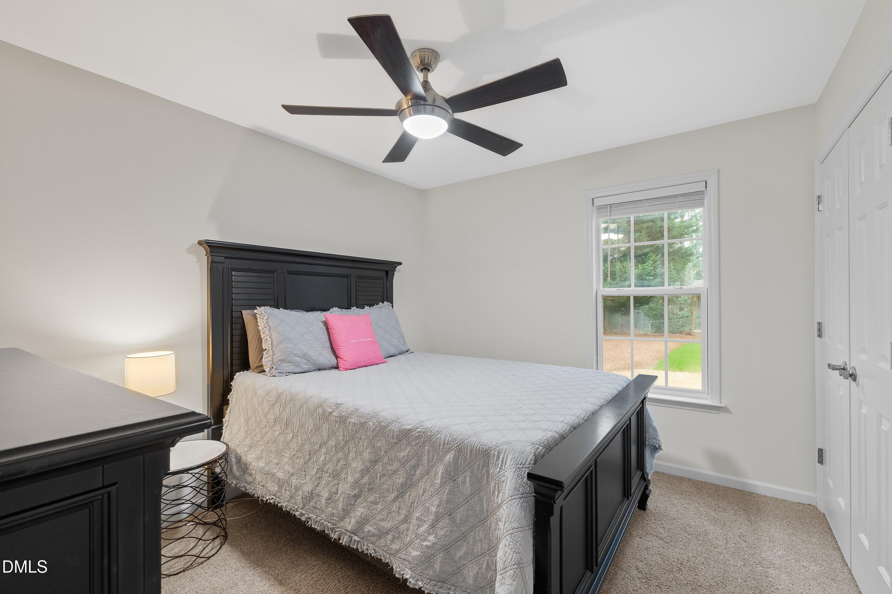 234 Linville Lane Willow Spring, NC 27592 - Photo 20 of 34 a bedroom with a bed and a ceiling fan