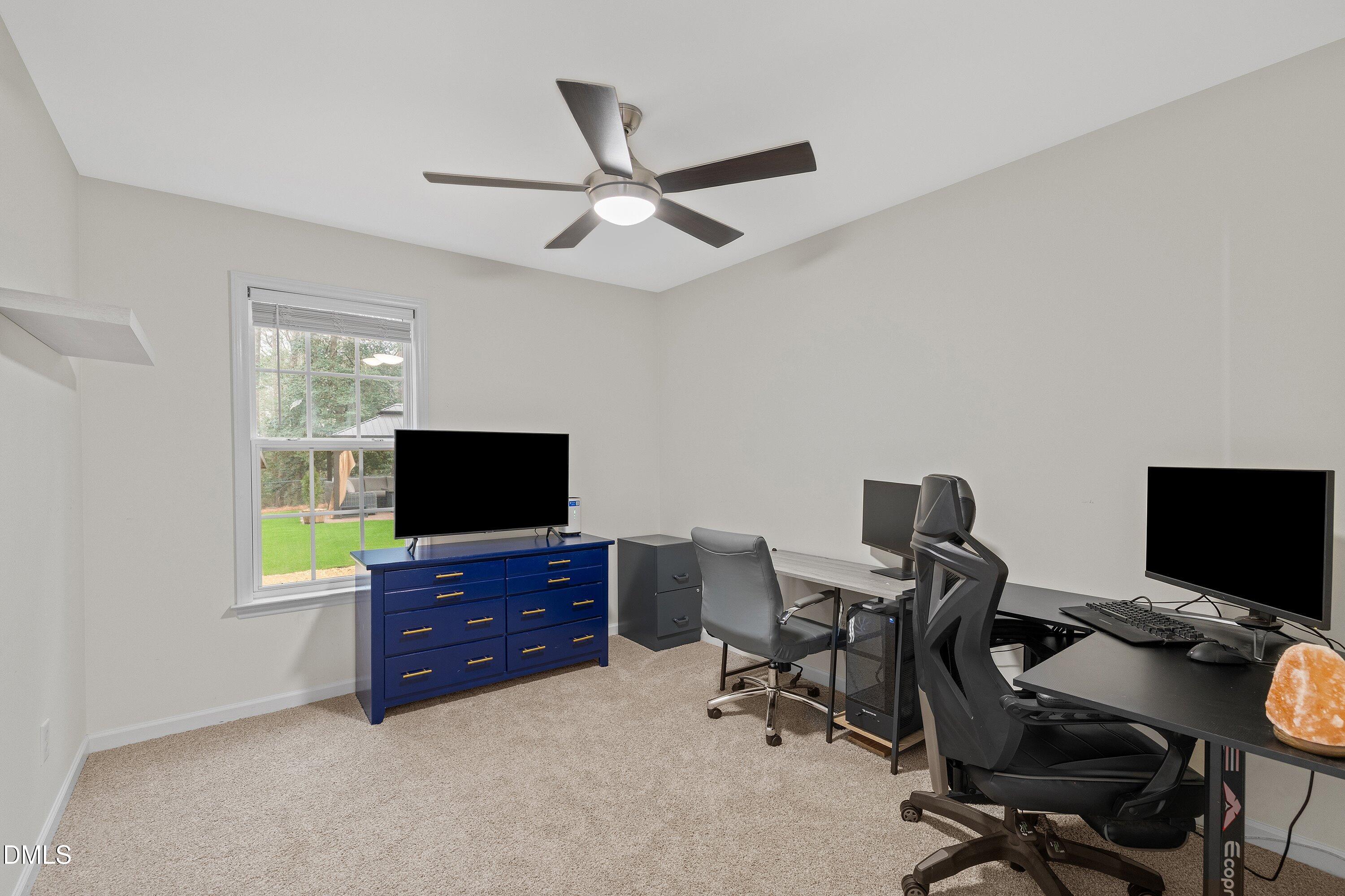 234 Linville Lane Willow Spring, NC 27592 - Photo 22 of 34 a view of a livingroom with workspace and a window