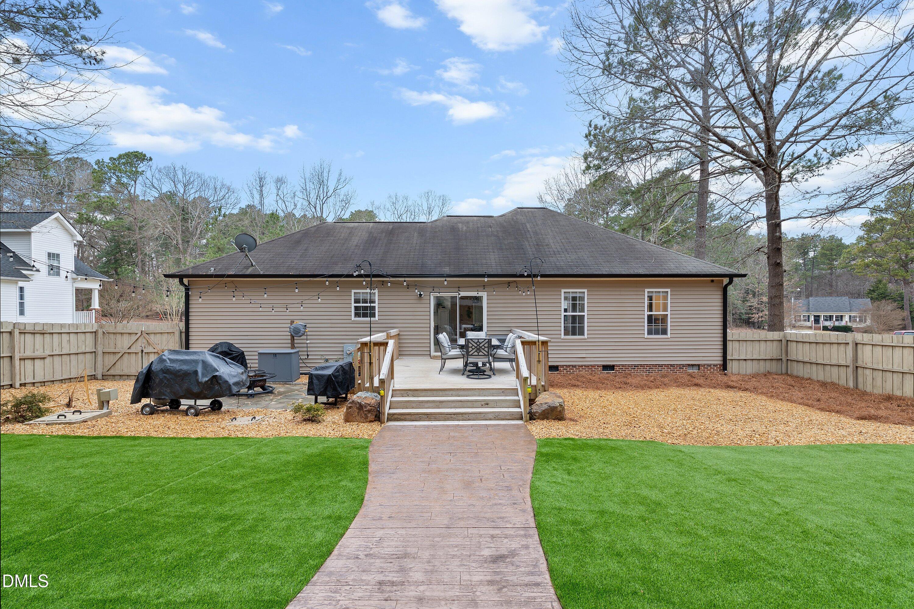 234 Linville Lane Willow Spring, NC 27592 - Photo 28 of 34 a front view of a house with garden and patio