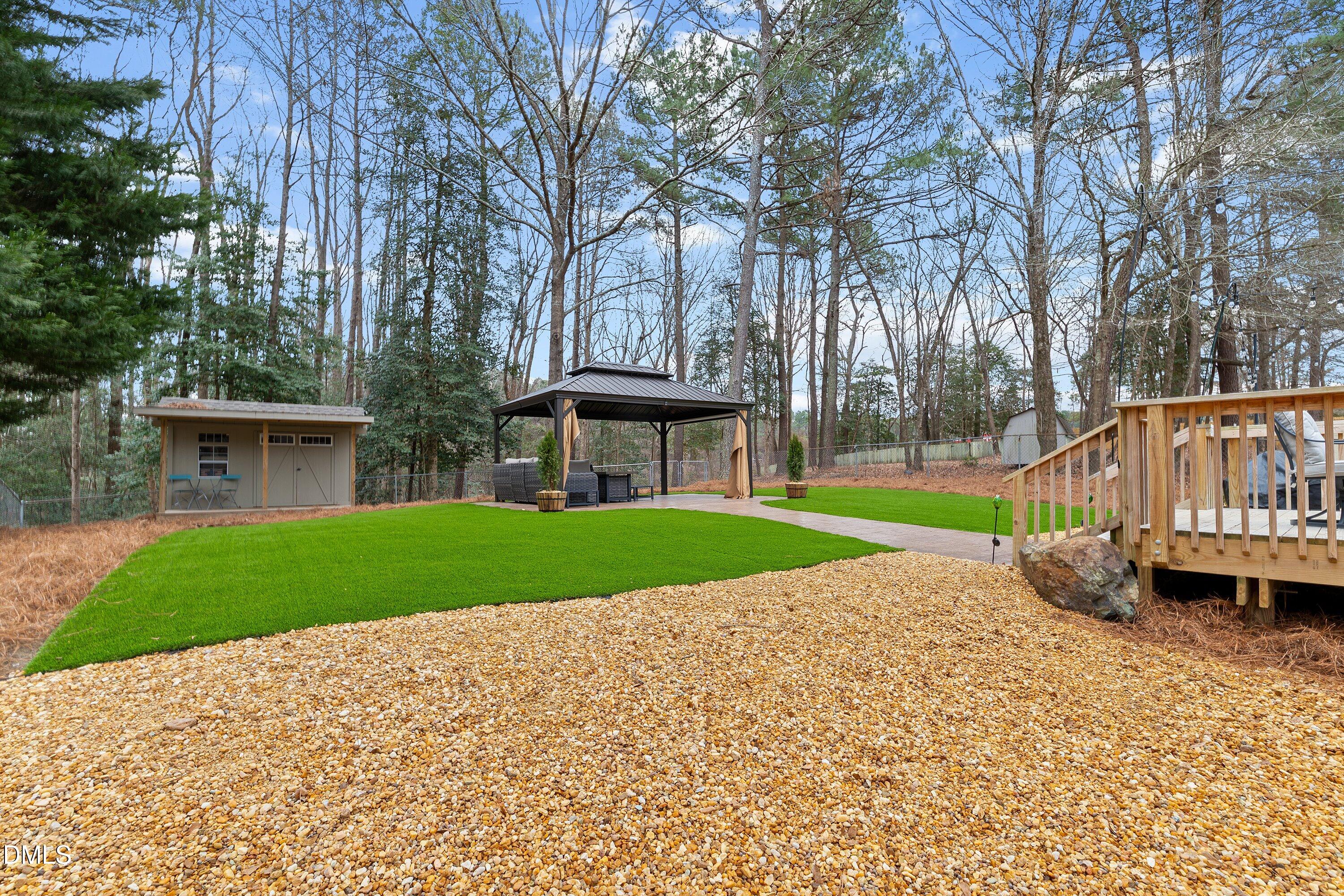 234 Linville Lane Willow Spring, NC 27592 - Photo 29 of 34 a view of a house with a yard and large trees