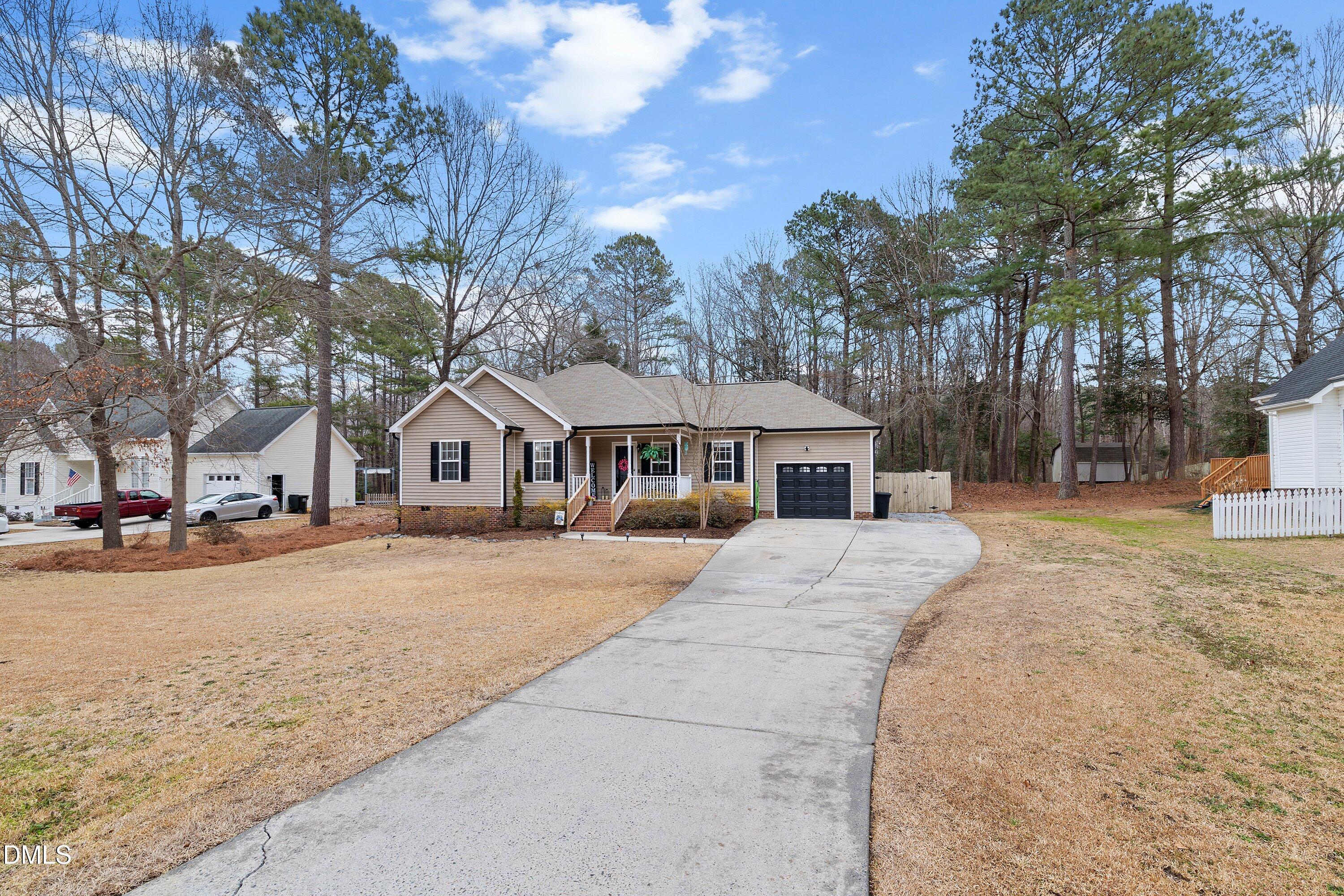 234 Linville Lane Willow Spring, NC 27592 - Photo 32 of 34 a front view of a house with yard