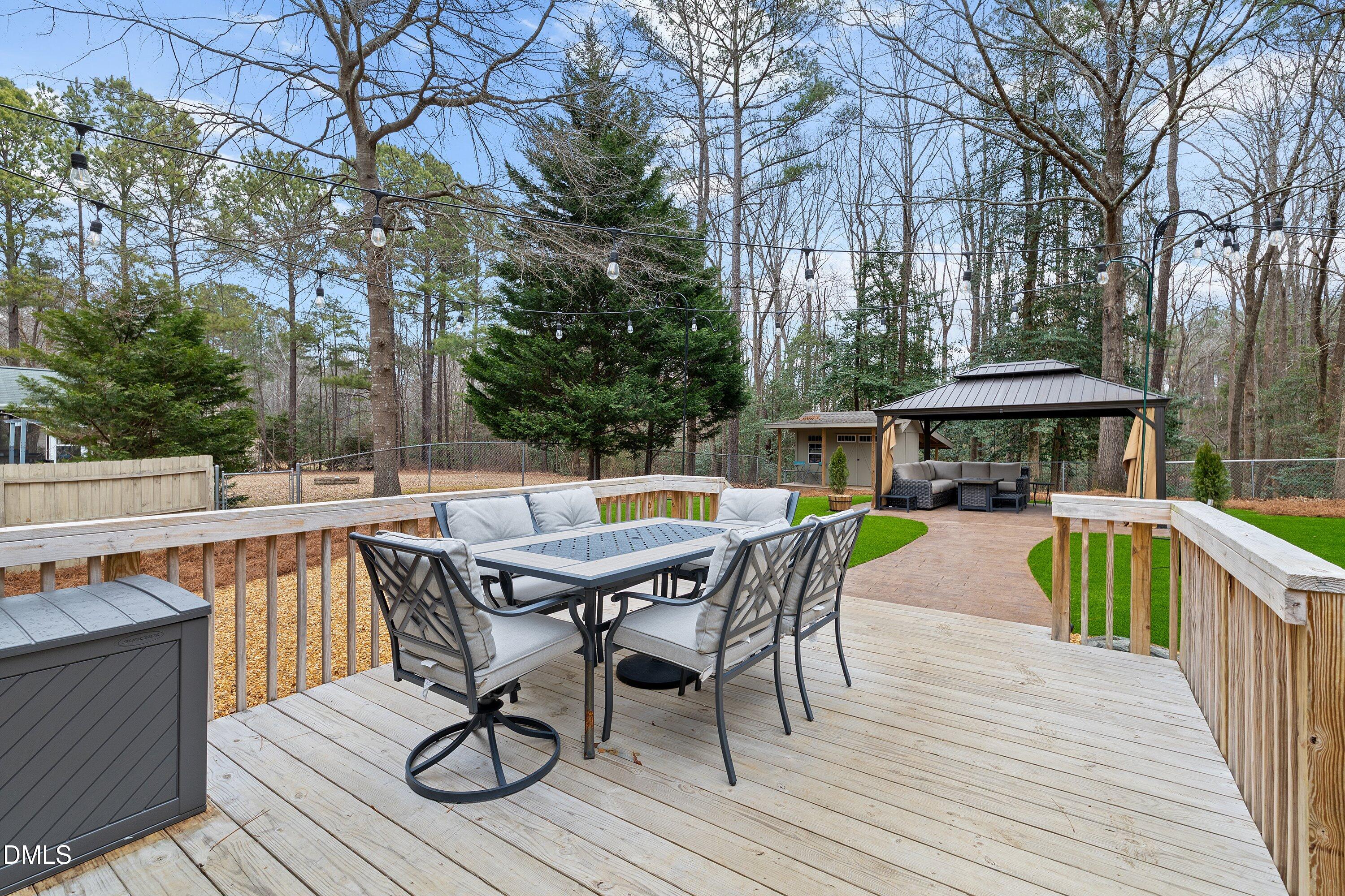 234 Linville Lane Willow Spring, NC 27592 - Photo 6 of 34 a view of house with wooden deck and furniture