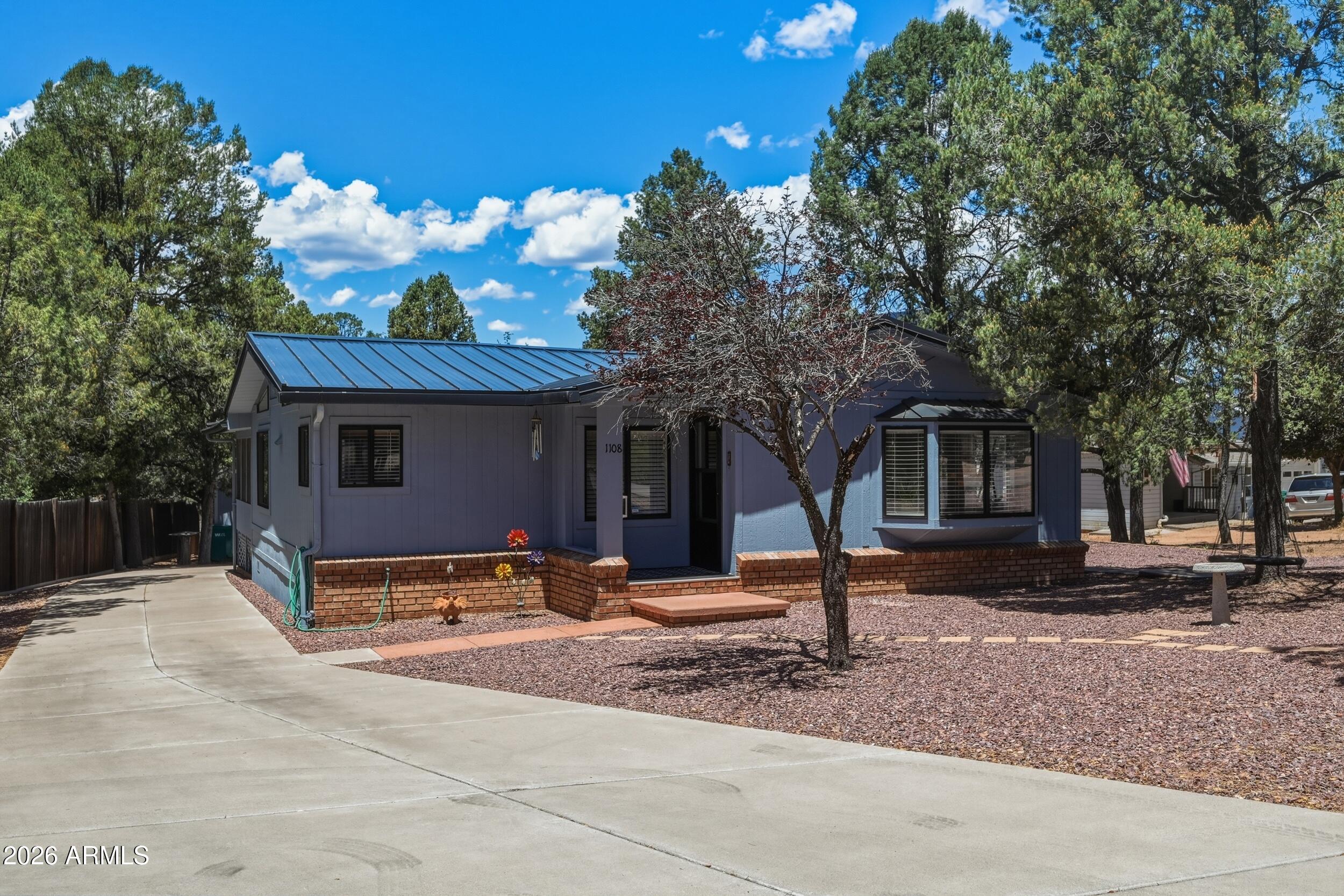1108 North William Tell Circle Payson, AZ 85541 - Photo 3 of 32 a wooden bench sitting in front of a house