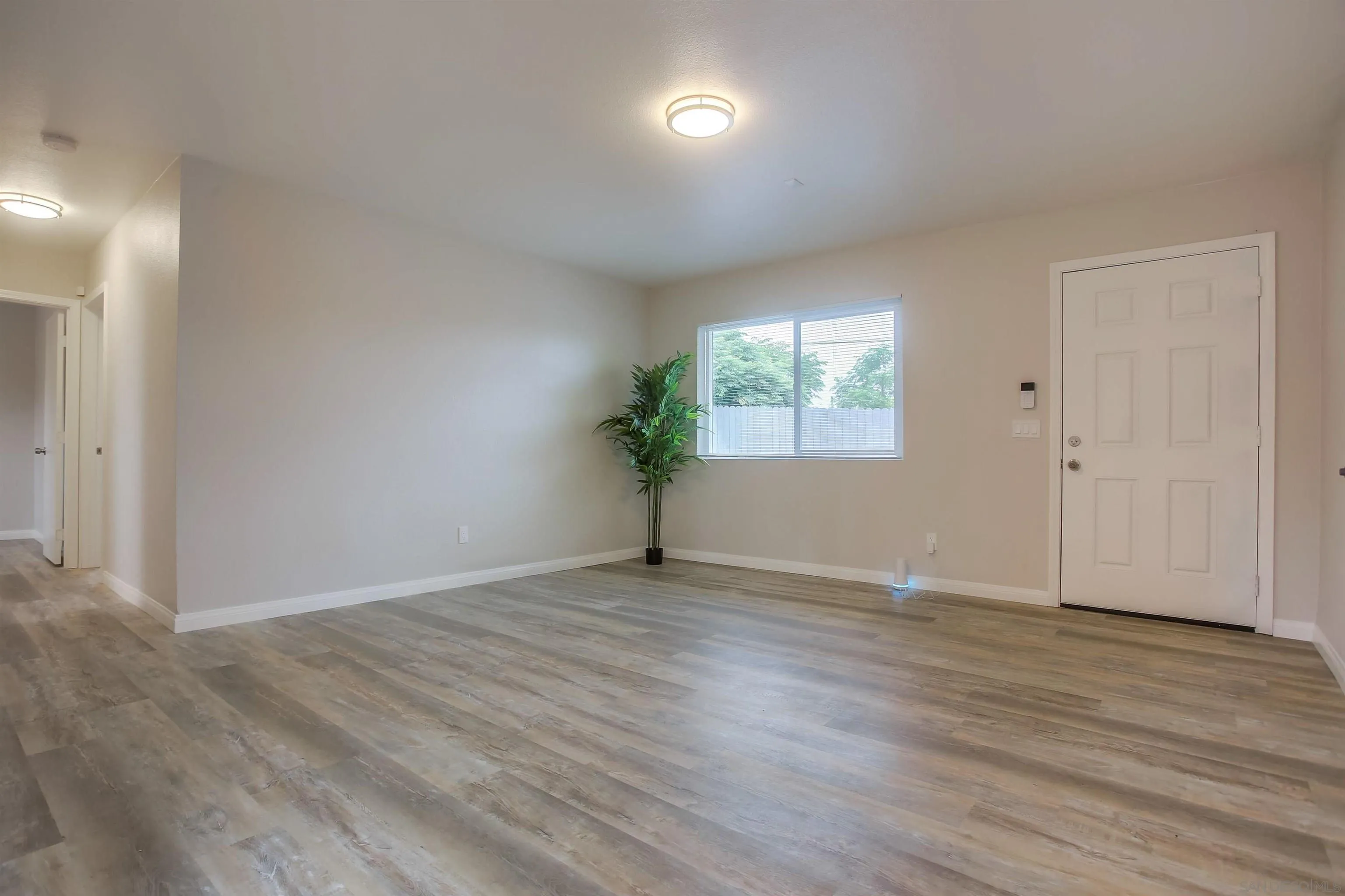 1055 Old Stage Road Fallbrook, CA 92028 - Photo 9 of 16 an empty room with wooden floor and windows