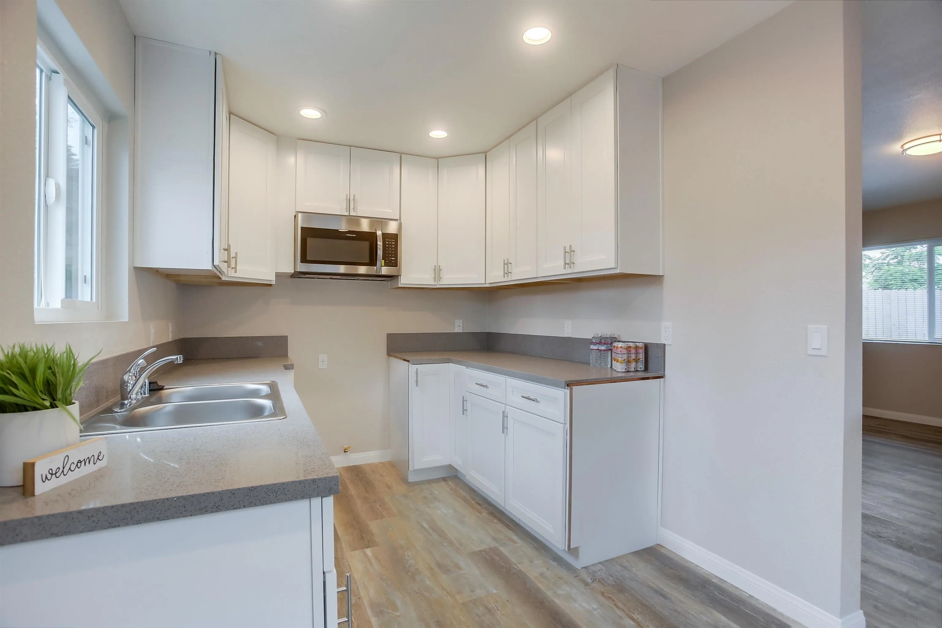 1055 Old Stage Road Fallbrook, CA 92028 - Photo 10 of 16 a kitchen with granite countertop white cabinets sink and stainless steel appliances
