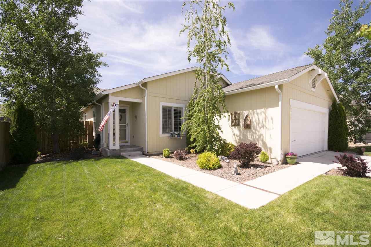 7716 Corso Street Reno, NV 89506 - Photo 1 of 1 a front view of a house with a yard and potted plants