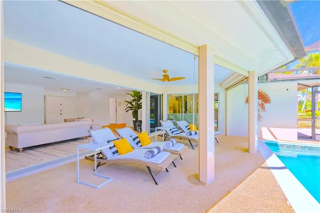 a living room with furniture and a floor to ceiling window