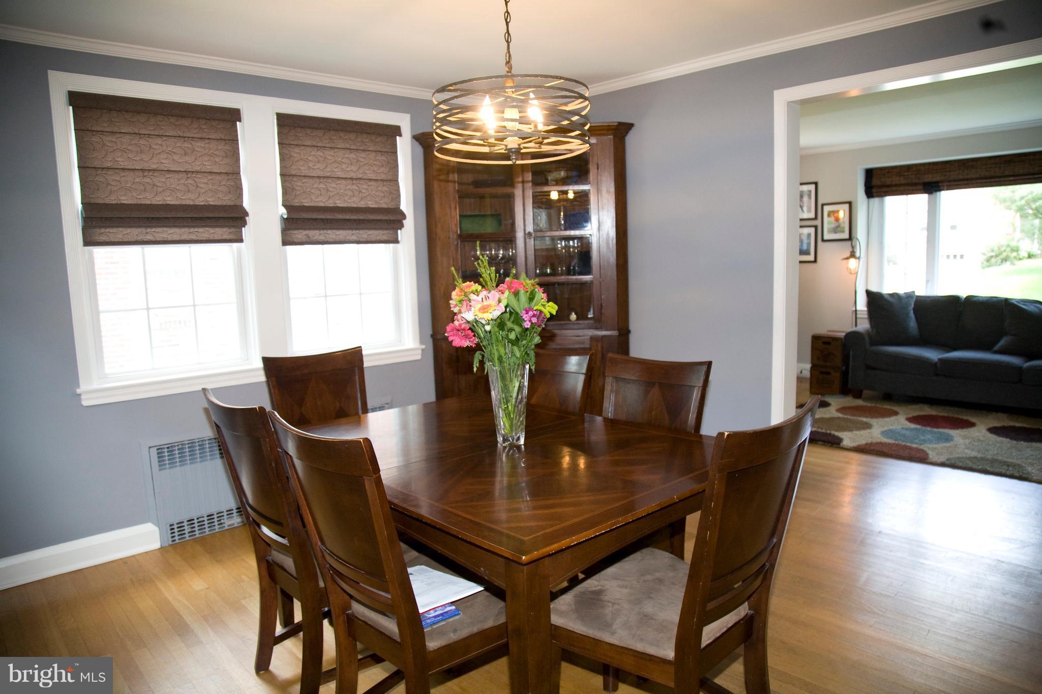 623 Overbrook Road Baltimore, MD 21212 - Photo 16 of 30 a dining room with furniture a chandelier and wooden floor