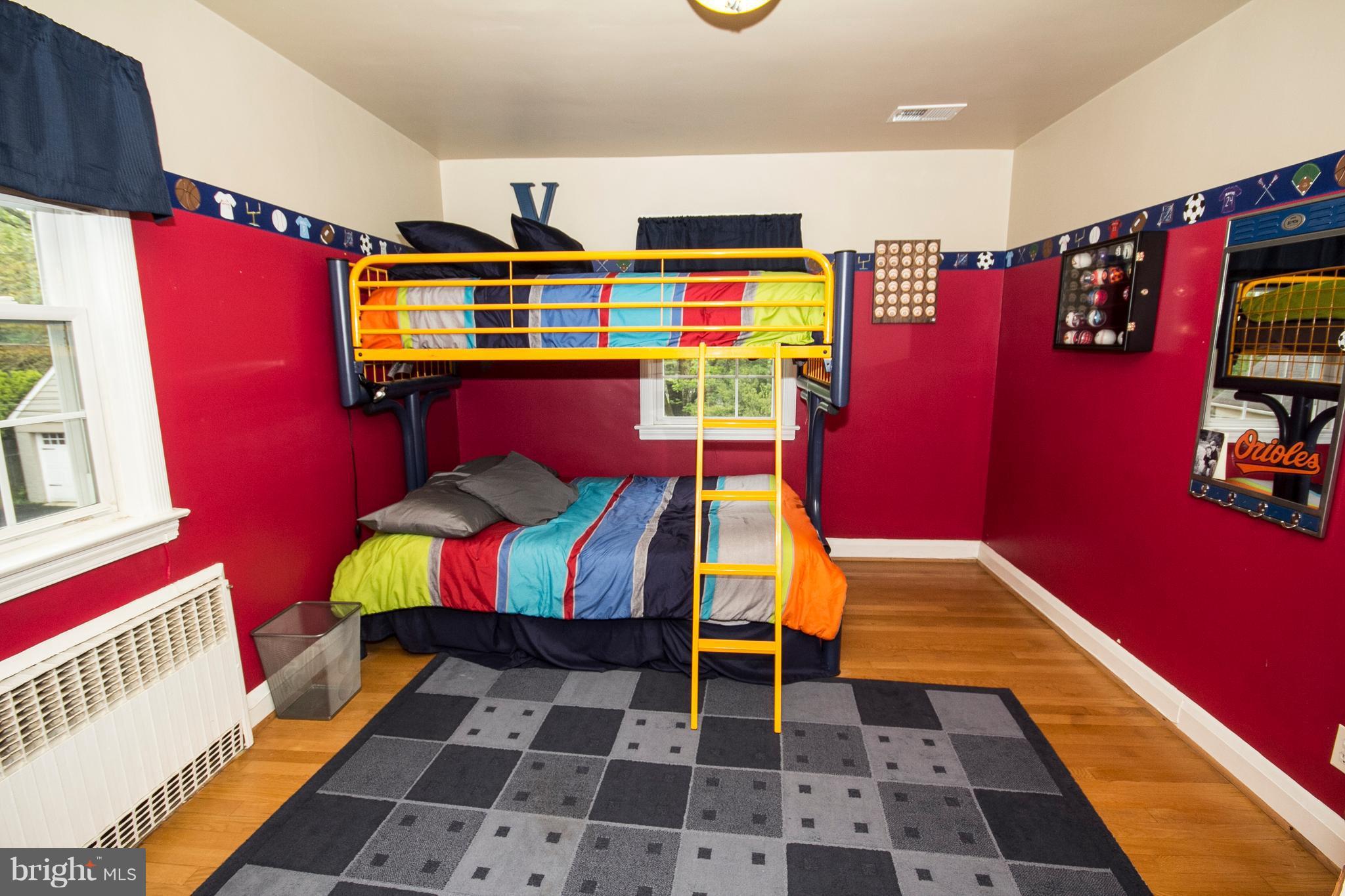623 Overbrook Road Baltimore, MD 21212 - Photo 23 of 30 a bedroom with a bed and wooden floor