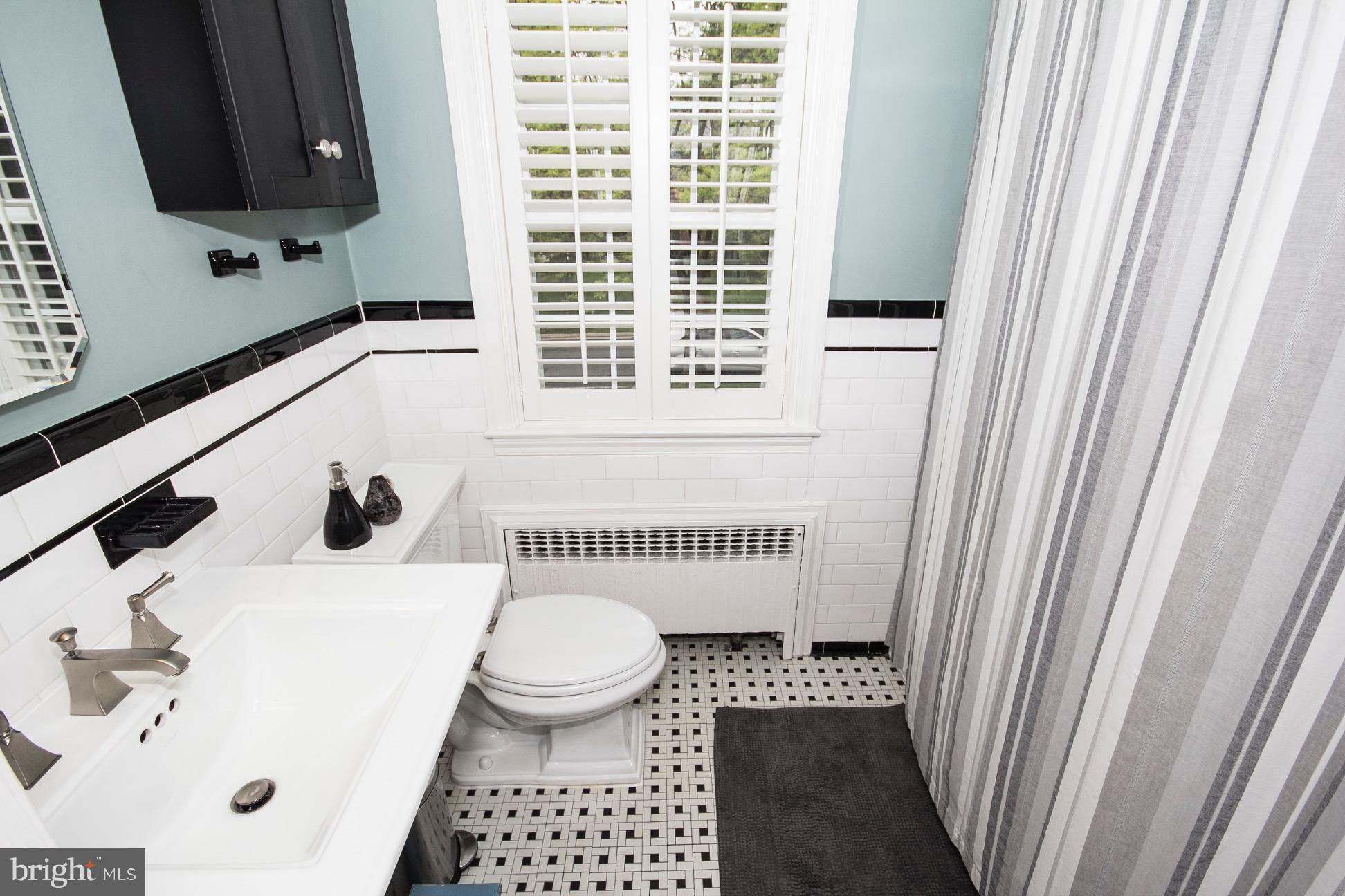 623 Overbrook Road Baltimore, MD 21212 - Photo 24 of 30 a bathroom with a sink a toilet and a mirror