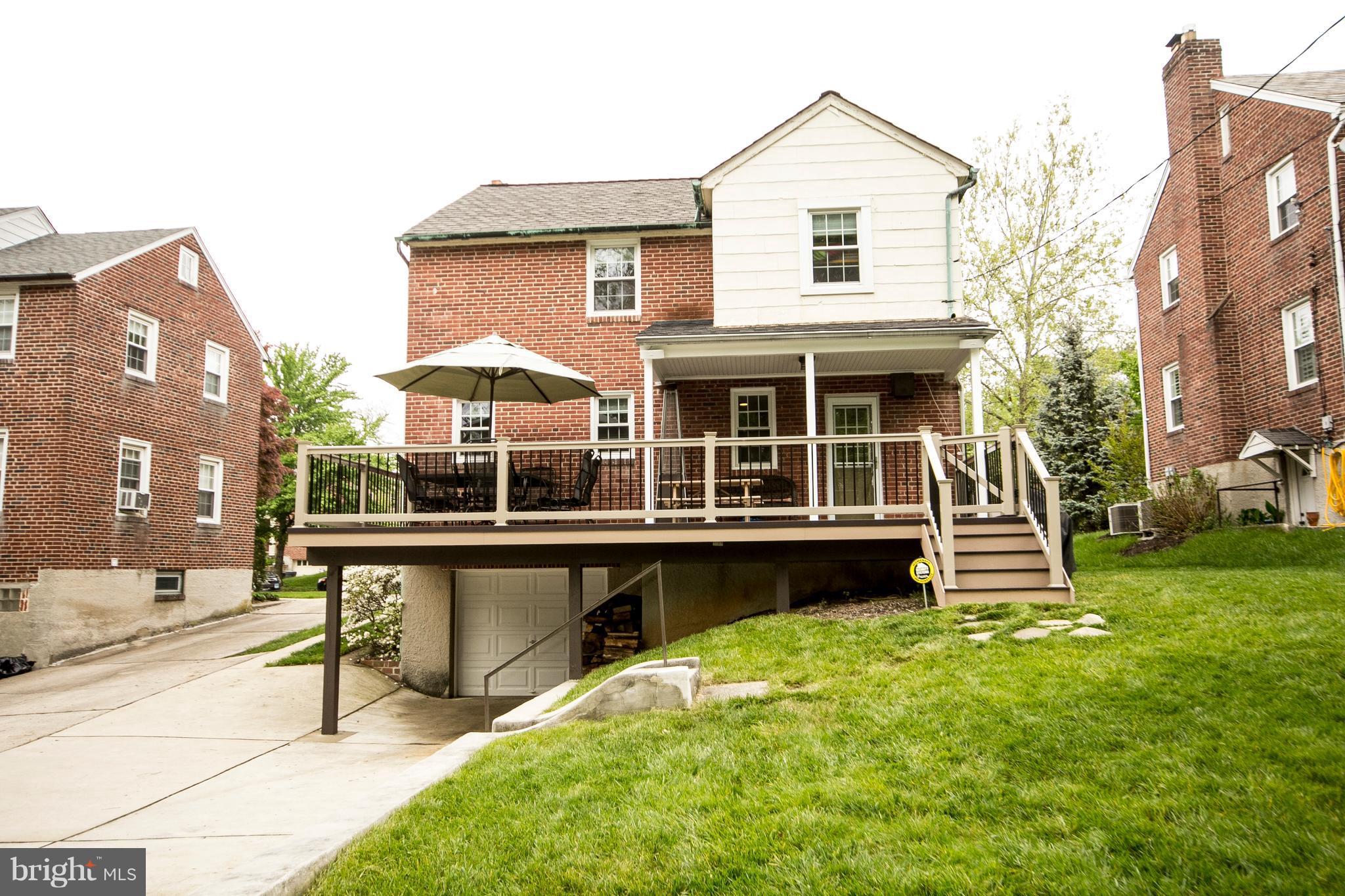 623 Overbrook Road Baltimore, MD 21212 - Photo 5 of 30 a front view of a house with a yard table and chairs