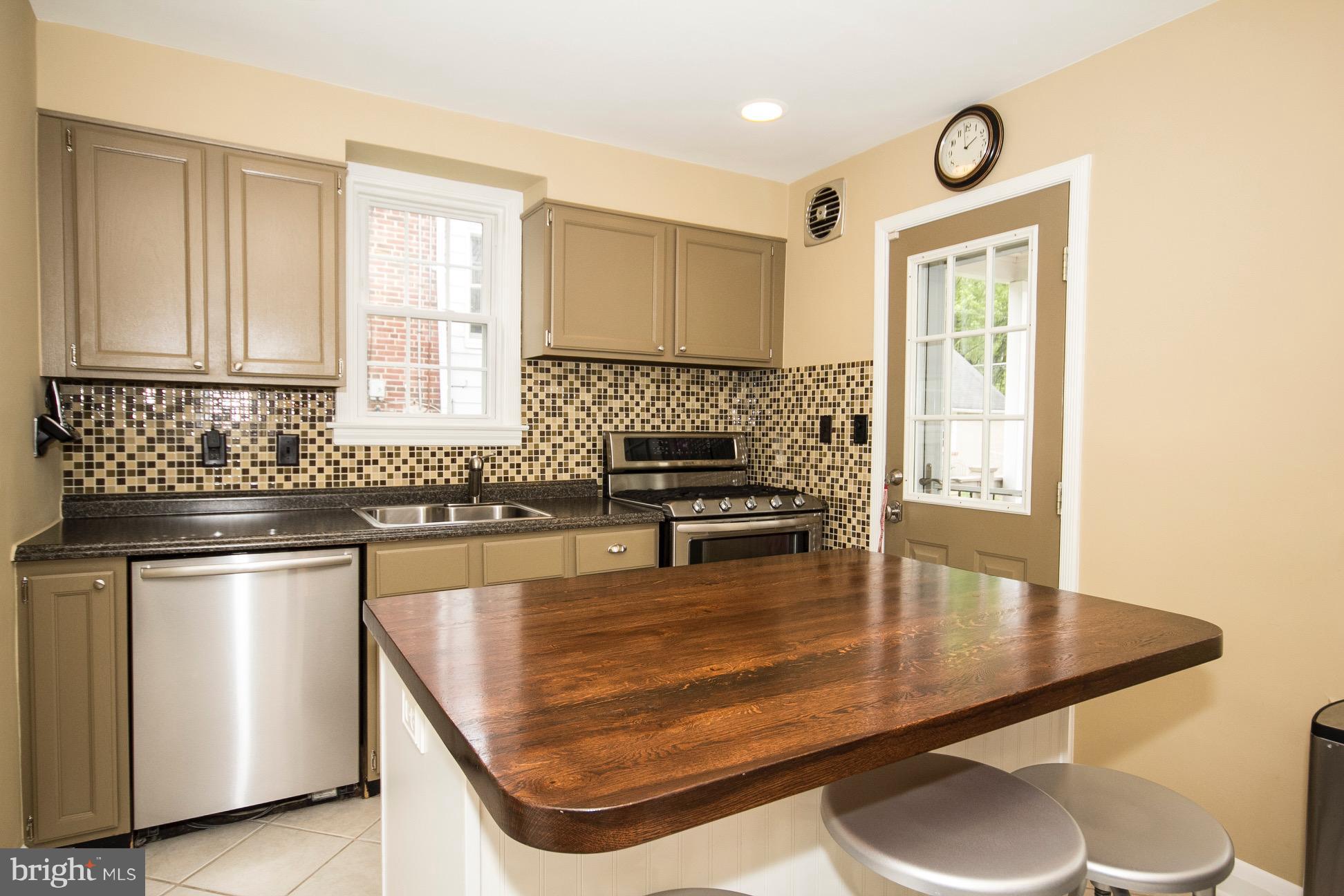 623 Overbrook Road Baltimore, MD 21212 - Photo 7 of 30 a kitchen with kitchen island a sink stove and cabinets