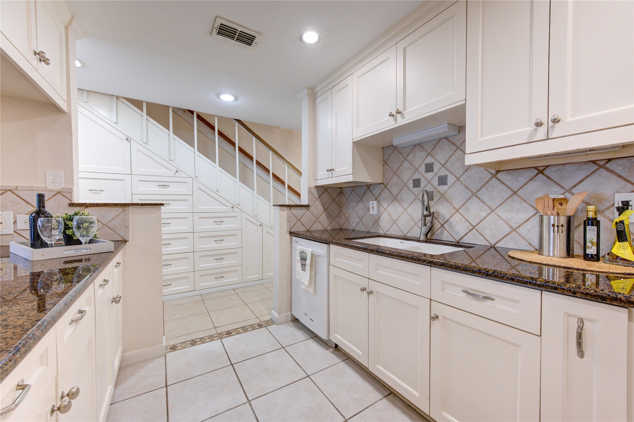 2232 South Piney Point Road, Unit 110 Houston, TX 77063 - Photo 3 of 21 Beautifully updated kitchen featuring granite countertops, custom cabinetry, designer tile backsplash, and abundant prep space for cooking and entertaining.