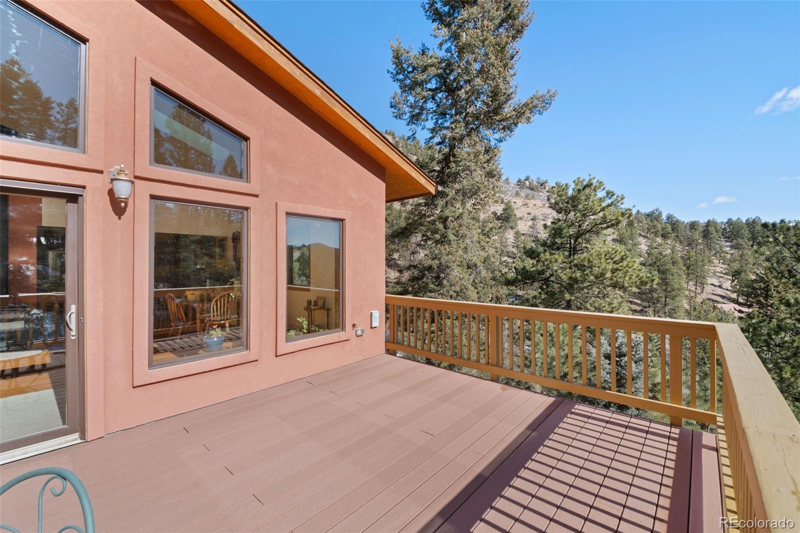 1269 Roland Drive Bailey, CO 80421 - Photo 13 of 38 a view of balcony with wooden floor and fence