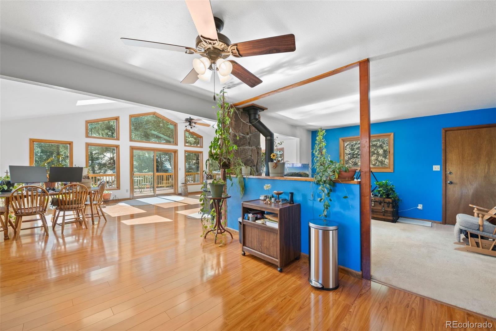1269 Roland Drive Bailey, CO 80421 - Photo 16 of 38 a view of a dining room kitchen with furniture a chandelier and wooden floor