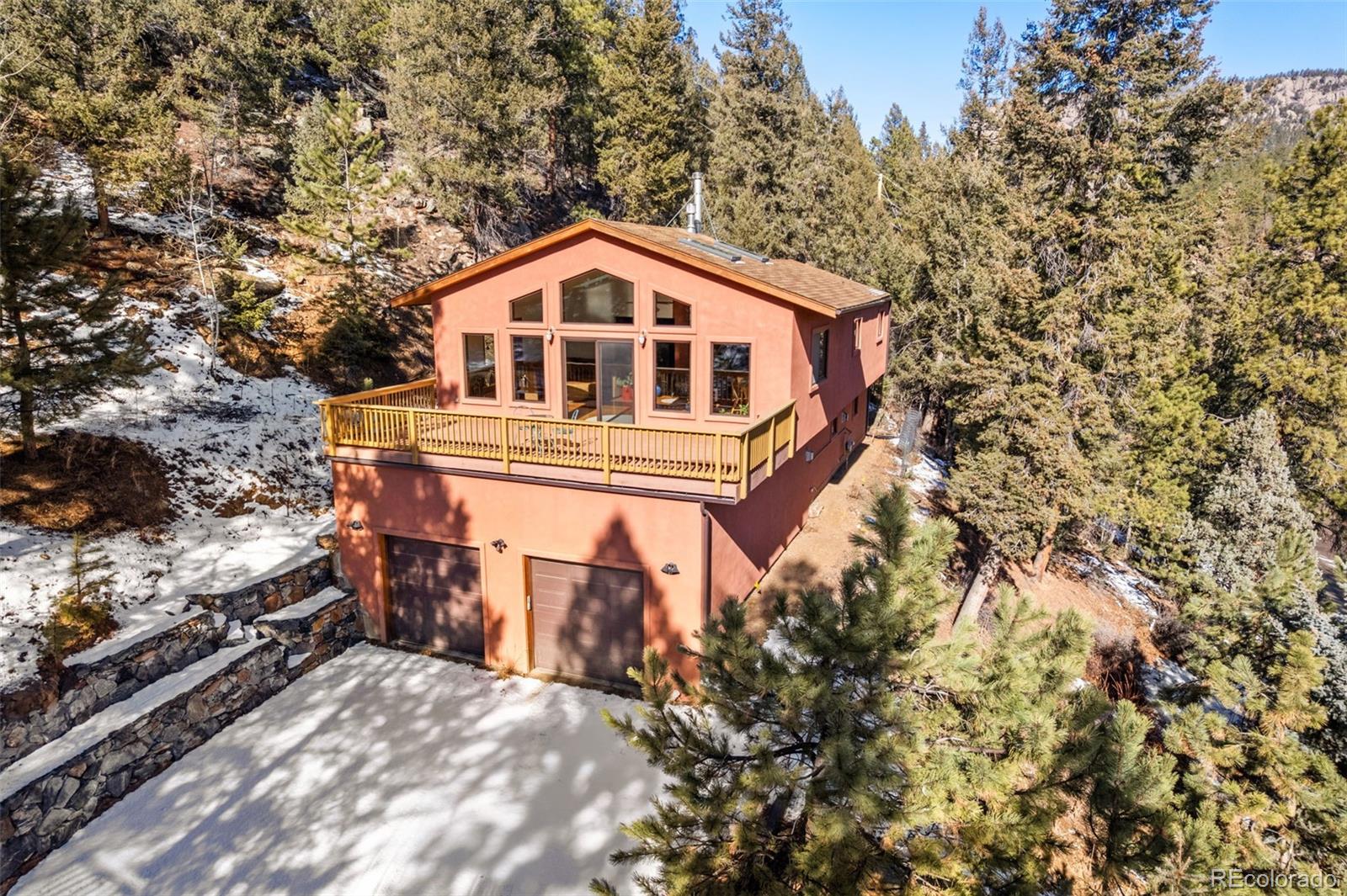 1269 Roland Drive Bailey, CO 80421 - Photo 2 of 38 a front view of a house with a yard