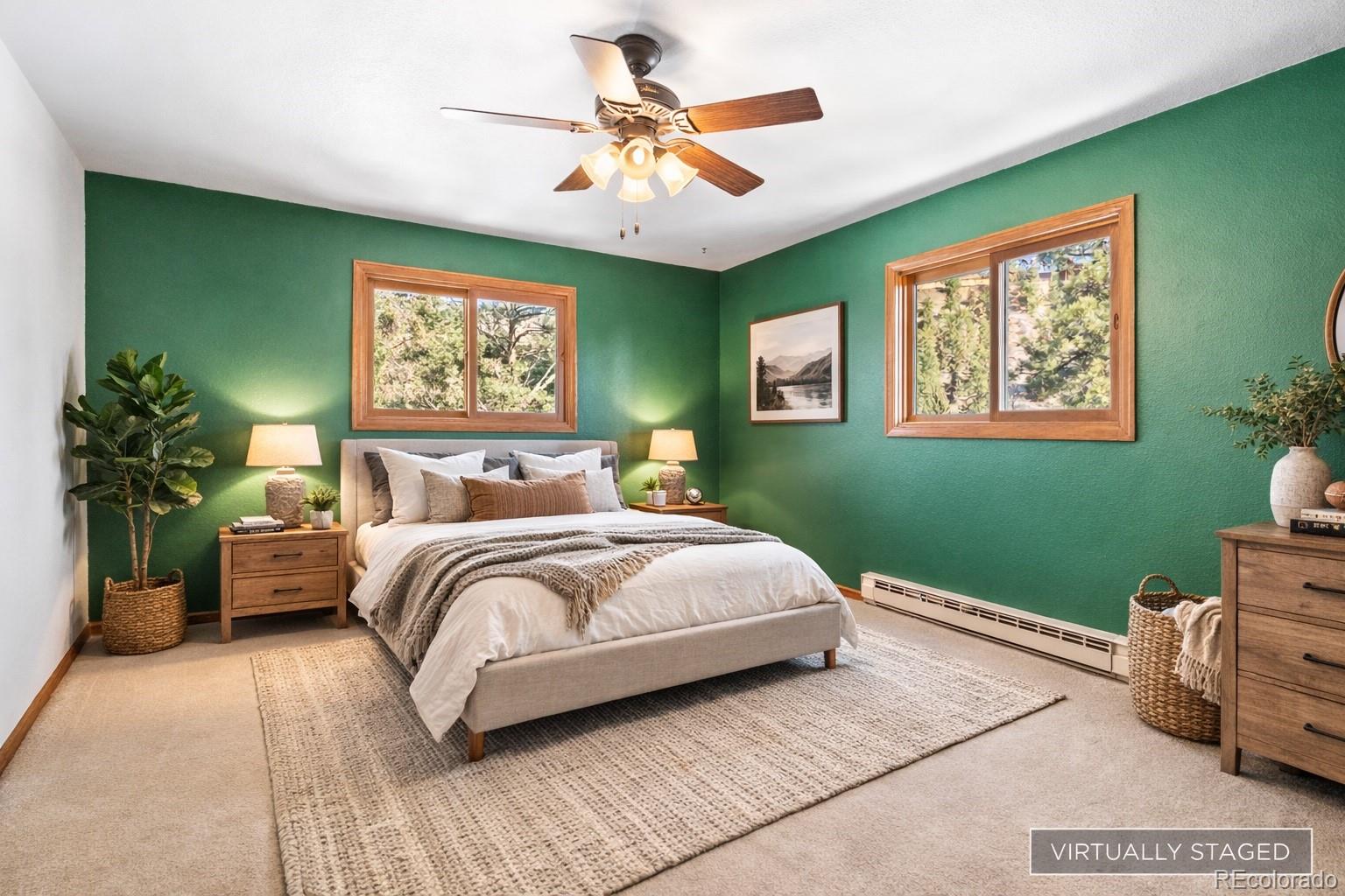 1269 Roland Drive Bailey, CO 80421 - Photo 23 of 38 a bedroom with a bed and a chandelier