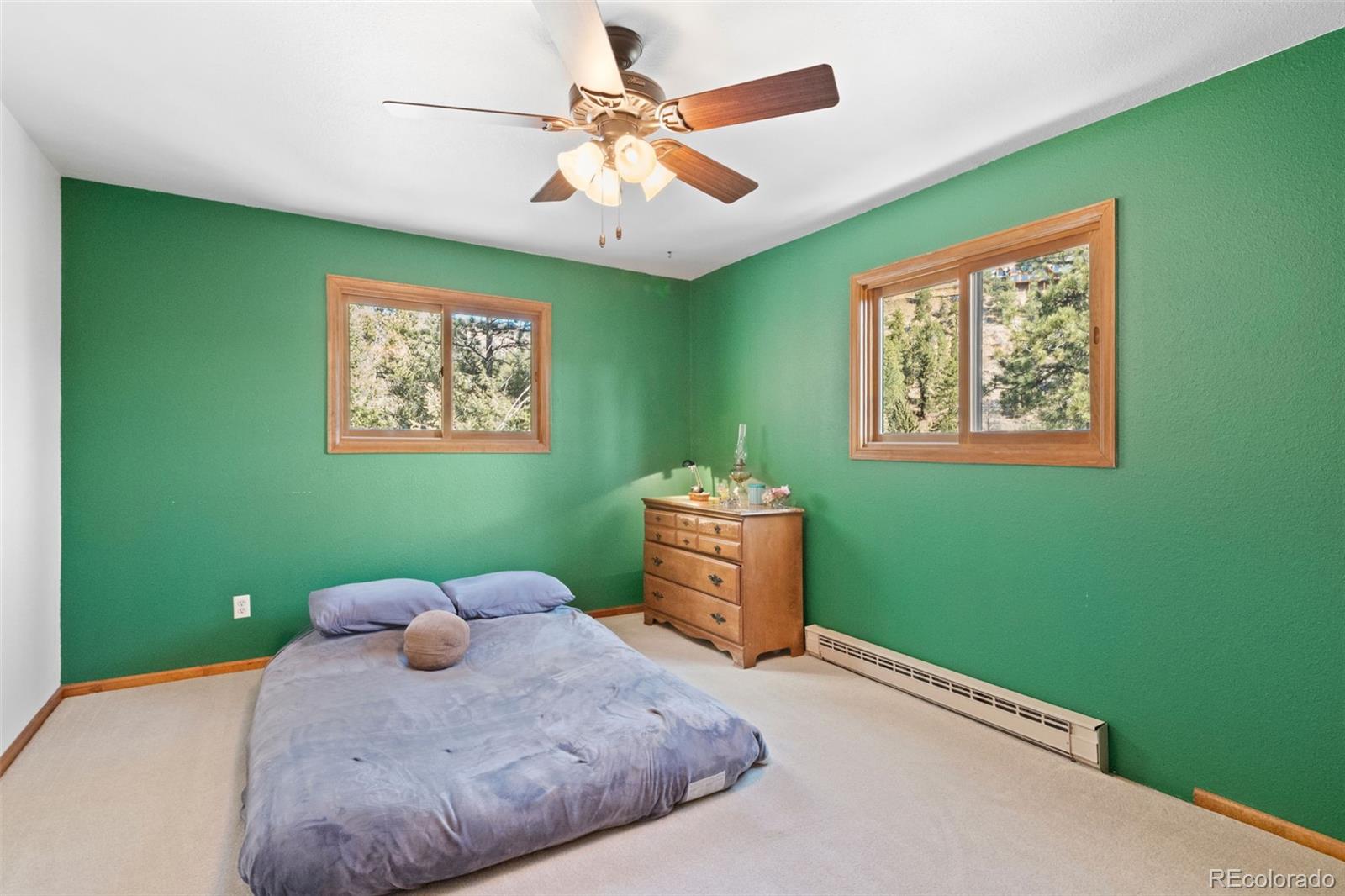 1269 Roland Drive Bailey, CO 80421 - Photo 24 of 38 a bedroom with a bed and a window