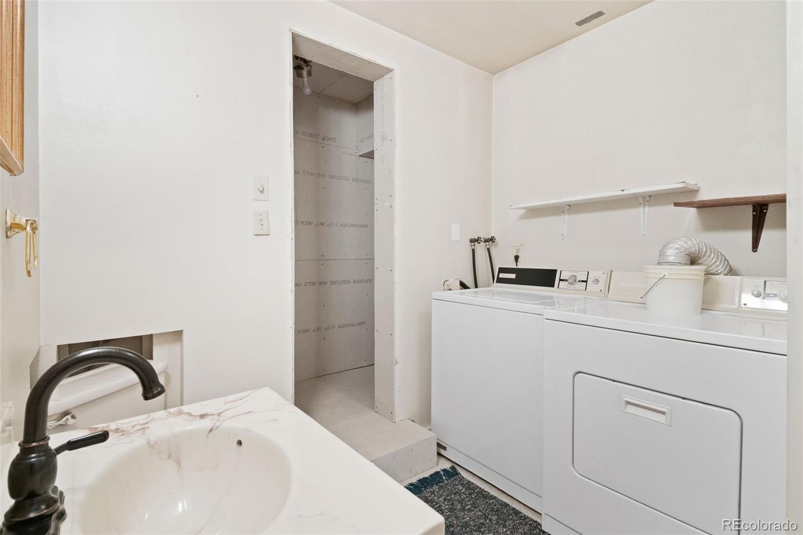 1269 Roland Drive Bailey, CO 80421 - Photo 30 of 38 a bathroom with a sink and a mirror